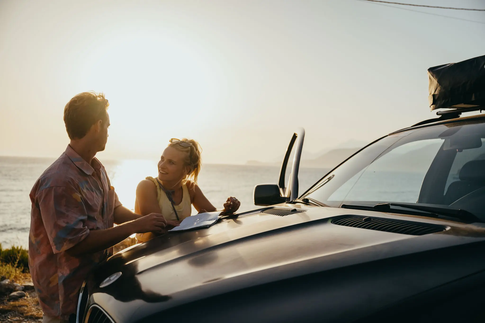 couple planning road trip by car at sunset in Albania