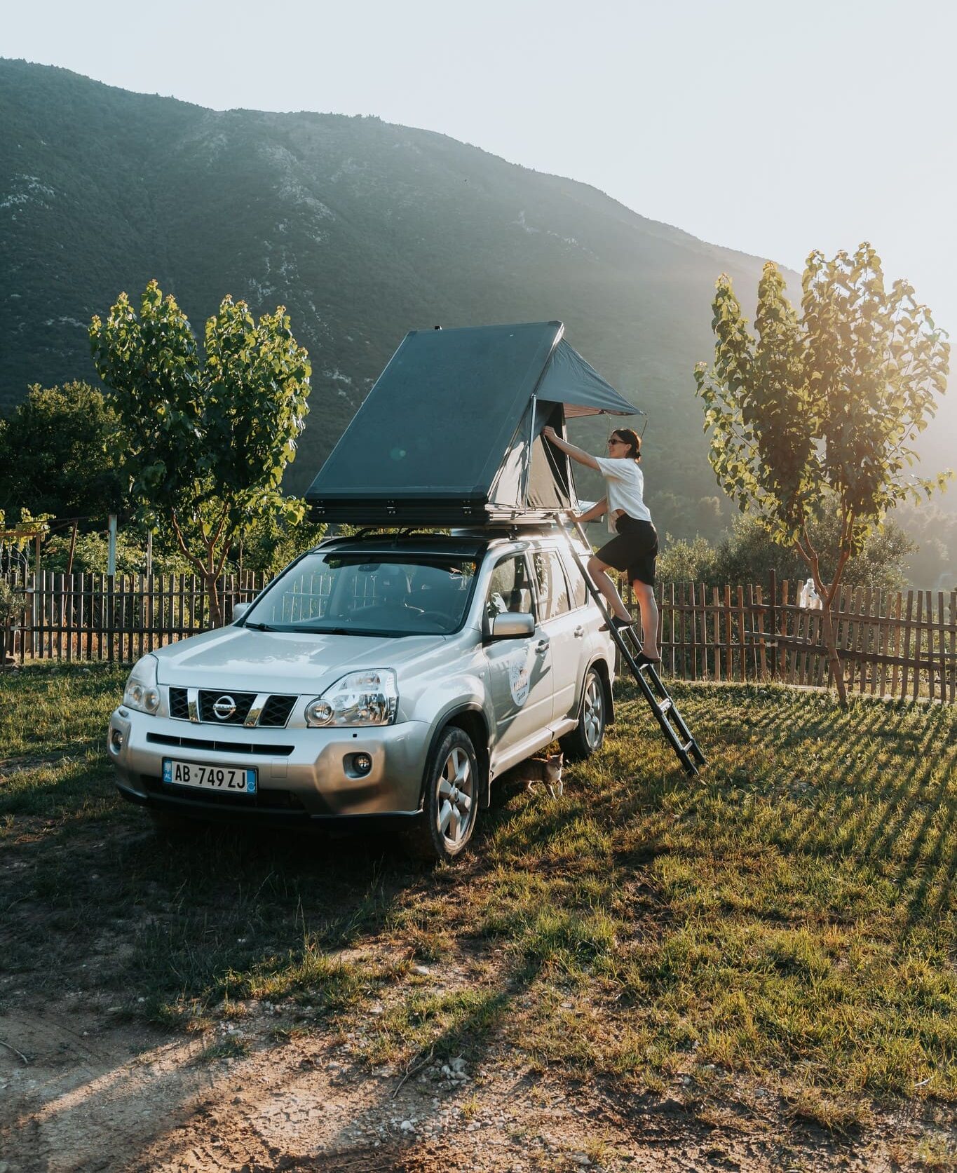 person setting up a rooftop tent on an SUV in Albania